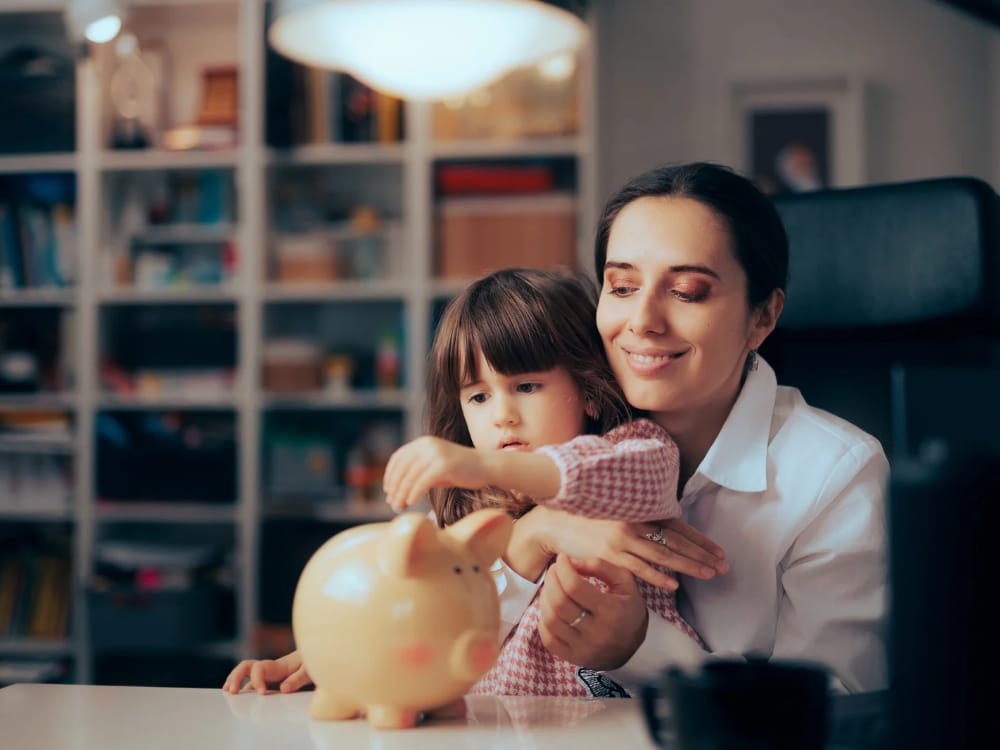 mãe educando sua filha a poupar. e ensinando sobre saúde financeira
e a importância de poupar