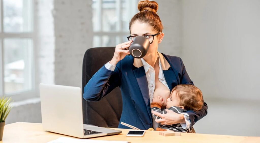 mulher empreendedora tomando chá e amamentando seu filho